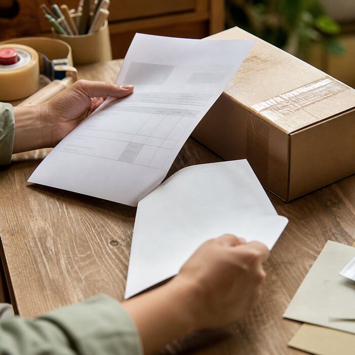 Blank invoice pages and a delivery note on a worktable
