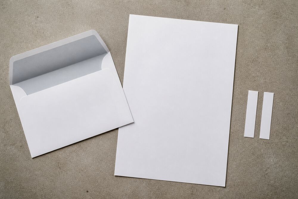 Blank reminder stationery and a pen under soft light
